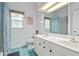 Well-lit bathroom with double vanity and blue tile flooring at 4893 Sw 4Th Cir, Ocala, FL 34471