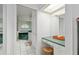 Well-lit bathroom featuring a vanity area, tile flooring, and a view of an elevated bathtub at 4893 Sw 4Th Cir, Ocala, FL 34471