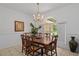 Dining room with wood table, chandelier, and large window offering natural light at 4893 Sw 4Th Cir, Ocala, FL 34471