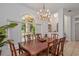 Formal dining room featuring elegant lighting, large windows, and seating for eight at 4893 Sw 4Th Cir, Ocala, FL 34471