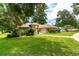 This well-maintained home features a manicured lawn and mature landscaping, showcasing its curb appeal at 4893 Sw 4Th Cir, Ocala, FL 34471
