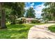 Traditional-style home with mature landscaping, a circular driveway, and inviting curb appeal at 4893 Sw 4Th Cir, Ocala, FL 34471