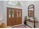 Elegant foyer featuring double doors with decorative glass and a stylish console table with mirror at 4893 Sw 4Th Cir, Ocala, FL 34471