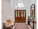 Inviting foyer featuring double doors, high ceilings, and decorative accents on the table at 4893 Sw 4Th Cir, Ocala, FL 34471