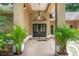 Inviting front entrance with a double-door entryway, elegant lighting, and potted plants at 4893 Sw 4Th Cir, Ocala, FL 34471