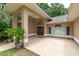 Charming front porch featuring double doors, elegant lighting, and manicured plants at 4893 Sw 4Th Cir, Ocala, FL 34471