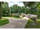 Charming home with a boat parked on the driveway, complemented by lovely tropical landscaping at 4893 Sw 4Th Cir, Ocala, FL 34471