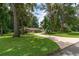 Charming home with a long driveway, mature trees, and lush landscaping, creating great curb appeal at 4893 Sw 4Th Cir, Ocala, FL 34471