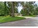 Beautiful home featuring a well-manicured lawn, shade trees, and a circular driveway at 4893 Sw 4Th Cir, Ocala, FL 34471