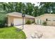 Attached garage with basketball hoop and separate structure with double doors for extra storage at 4893 Sw 4Th Cir, Ocala, FL 34471