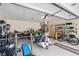 Garage containing a weight lifting station, bicycles, and a motorcycle at 4893 Sw 4Th Cir, Ocala, FL 34471