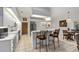Modern white kitchen featuring a breakfast bar, stainless appliances, and tiled flooring at 4893 Sw 4Th Cir, Ocala, FL 34471