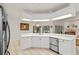 Bright kitchen features white cabinets, stainless steel appliances, and an open layout with views to the backyard at 4893 Sw 4Th Cir, Ocala, FL 34471