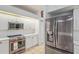 This kitchen is equipped with stainless steel appliances and white cabinets and countertops at 4893 Sw 4Th Cir, Ocala, FL 34471