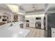 Bright, airy kitchen open to the living room with stainless steel appliances and white countertops at 4893 Sw 4Th Cir, Ocala, FL 34471