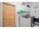 Clean laundry room featuring a modern washer and dryer, and storage cabinets at 4893 Sw 4Th Cir, Ocala, FL 34471