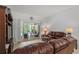 Relaxing living room boasts plush leather seating and sliding glass doors to the lanai at 4893 Sw 4Th Cir, Ocala, FL 34471