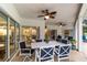 Covered patio with ceiling fans and an outdoor dining set at 4893 Sw 4Th Cir, Ocala, FL 34471