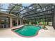 Screened-in pool area with a waterfall feature and outdoor seating at 4893 Sw 4Th Cir, Ocala, FL 34471