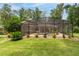 The screened-in pool is surrounded by a green lawn and colorful landscaping, perfect for outdoor relaxation at 4893 Sw 4Th Cir, Ocala, FL 34471