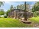 This home features a lovely screened-in pool with colorful landscaping and a brick planter around a palm tree at 4893 Sw 4Th Cir, Ocala, FL 34471