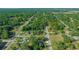 Distant aerial view of a residential community with tree-lined streets and lush green spaces at 19662 Sw Marine Blvd, Dunnellon, FL 34431