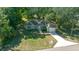 Aerial view of a well-maintained home with a long driveway and meticulously manicured front lawn at 19662 Sw Marine Blvd, Dunnellon, FL 34431