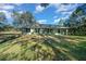 Charming single-story home with lush green lawn and mature trees under a bright blue sky at 19662 Sw Marine Blvd, Dunnellon, FL 34431