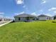 A spacious backyard with a covered patio offers plenty of room for outdoor activities at 5892 Sw 82Nd Ln, Ocala, FL 34476