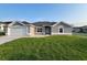 Charming single-story home featuring a well-manicured lawn, attached two-car garage, and neutral exterior paint at 5892 Sw 82Nd Ln, Ocala, FL 34476