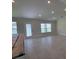 Open living space featuring tile floors, recessed lighting, and a door to the backyard at 5892 Sw 82Nd Ln, Ocala, FL 34476