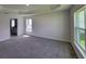 A spacious bedroom includes a tray ceiling, plush carpet, and large windows for natural light at 5892 Sw 82Nd Ln, Ocala, FL 34476