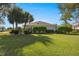 Green backyard with lush hedges along the back of the property at 7290 Se 172Nd Legacy Ln, The Villages, FL 32162