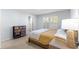 Well-lit bedroom featuring tile floors, plantation shutters, and a decorative storage chest at 7290 Se 172Nd Legacy Ln, The Villages, FL 32162