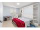 Cozy bedroom featuring a built-in Murphy bed with shelving, a sun-filled window, and neutral wall paint at 7290 Se 172Nd Legacy Ln, The Villages, FL 32162