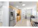 Bright kitchen featuring stainless steel appliances, tile flooring, and light wood cabinetry at 7290 Se 172Nd Legacy Ln, The Villages, FL 32162