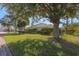 Well-maintained side yard with mature shade tree and lush green lawn at 7290 Se 172Nd Legacy Ln, The Villages, FL 32162