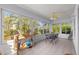 Bright sunroom filled with an abundance of natural light, perfect for enjoying plants and nature at 7290 Se 172Nd Legacy Ln, The Villages, FL 32162