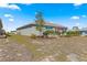 Well-kept backyard featuring lush landscaping, a patio area, and a glimpse of nearby houses at 9617 Sw 102Nd Ter, Ocala, FL 34481