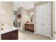 Bright bathroom featuring double doors, tile floors, and a vanity with granite countertop at 9617 Sw 102Nd Ter, Ocala, FL 34481