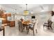 Open concept dining area features a modern chandelier, tile flooring and flows into the living room and kitchen at 9617 Sw 102Nd Ter, Ocala, FL 34481