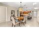 Open-concept dining room featuring a chandelier, dining table, and seating next to the kitchen at 9617 Sw 102Nd Ter, Ocala, FL 34481