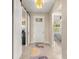 Inviting entryway featuring neutral paint, tile flooring, a decorative rug and a clear view to a bedroom at 9617 Sw 102Nd Ter, Ocala, FL 34481