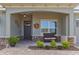 Charming front porch with stone accents, decorative wreath, and a cozy wicker bench at 9617 Sw 102Nd Ter, Ocala, FL 34481