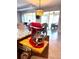 Kitchen mixer on wood pullout with seating area and view to outdoors at 9617 Sw 102Nd Ter, Ocala, FL 34481