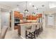 Modern kitchen featuring stainless steel appliances, dark wood cabinetry, granite countertops, and bar stool seating at 9617 Sw 102Nd Ter, Ocala, FL 34481