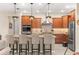 Modern kitchen featuring stainless steel appliances, granite countertops, tile backsplash, and bar stool seating at 9617 Sw 102Nd Ter, Ocala, FL 34481