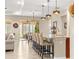 Bright kitchen featuring granite countertops, bar stool seating, modern lighting fixtures, and access to the patio at 9617 Sw 102Nd Ter, Ocala, FL 34481