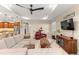 Bright, open living area with a cozy seating arrangement, modern furnishings, and seamless flow to kitchen at 9617 Sw 102Nd Ter, Ocala, FL 34481