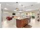 Open-concept living room and kitchen area featuring bar stool seating and stainless steel appliances at 9617 Sw 102Nd Ter, Ocala, FL 34481